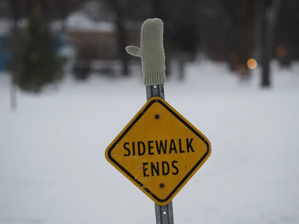 a mitt stuck on the end of a sign