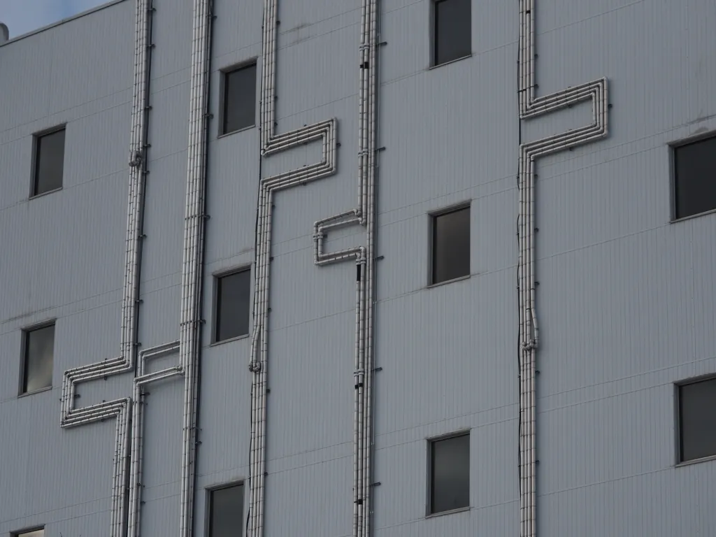 metal pipes with abrupt turns on a large building