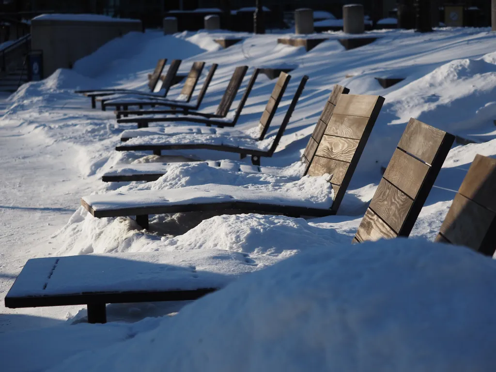 snow-covered deck chairs