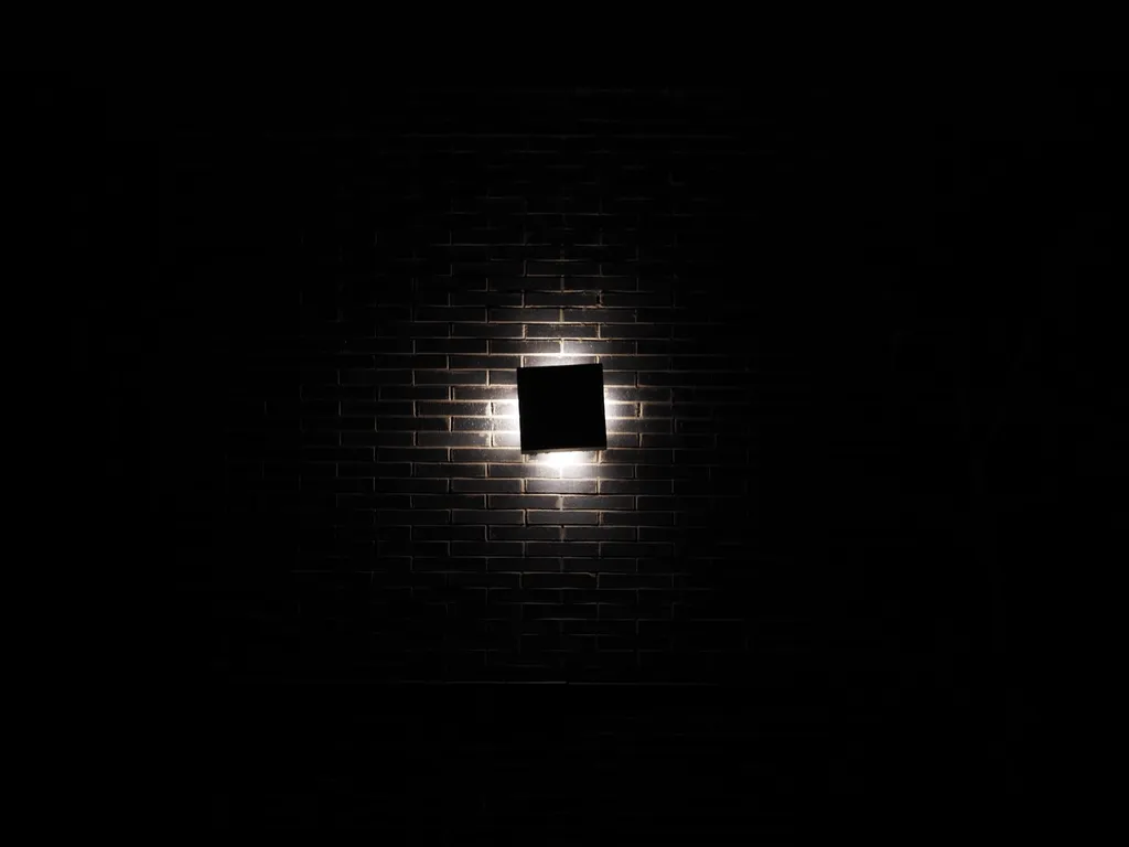 a brick wall lit up at night