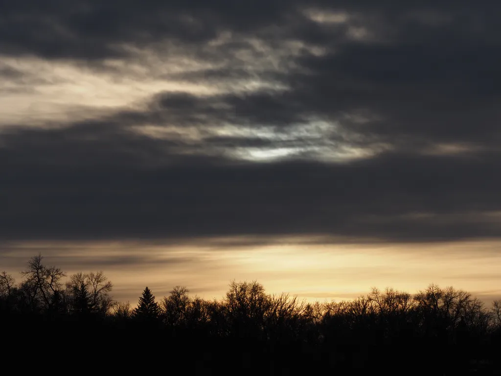 a setting sun on a cloudy day