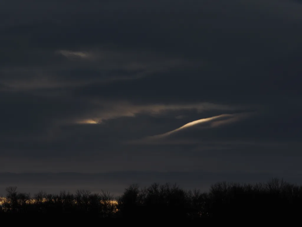 light peaking out from between clouds