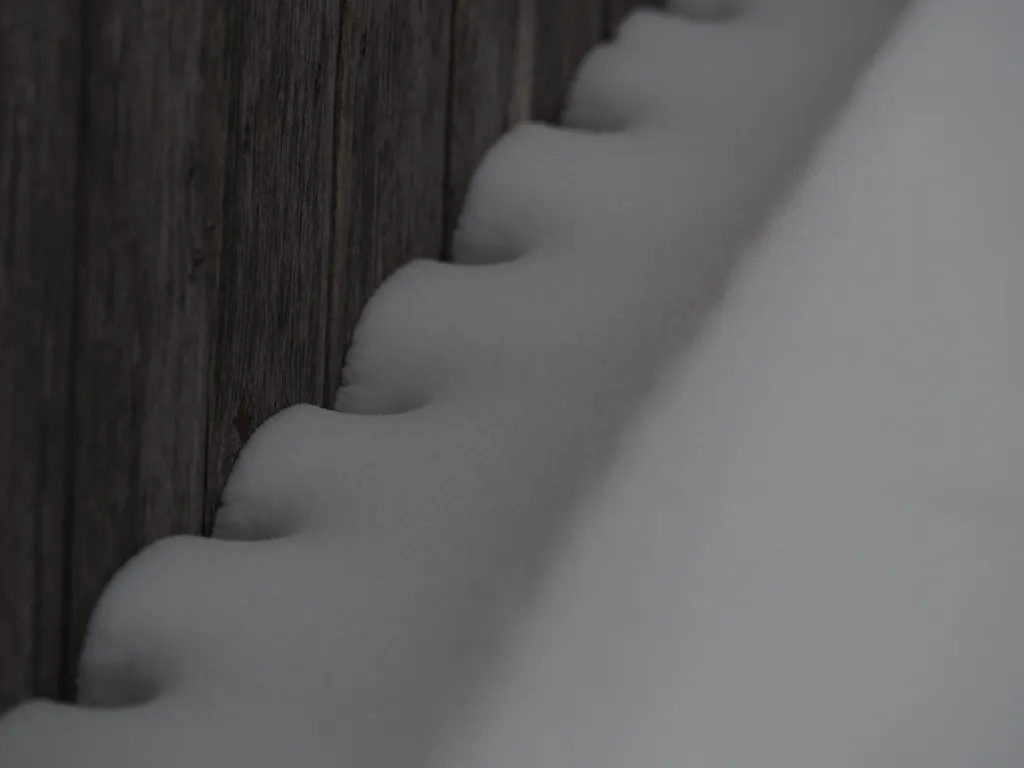 snow along a fence