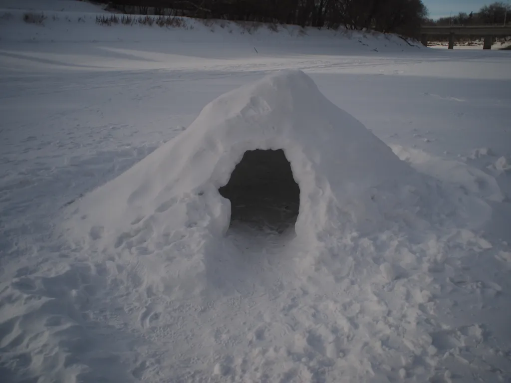 a snow hut on a river