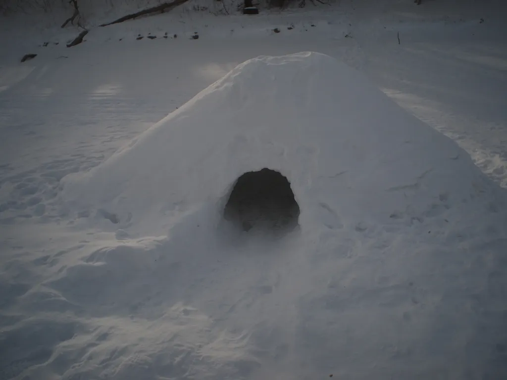 a snow hut on a river