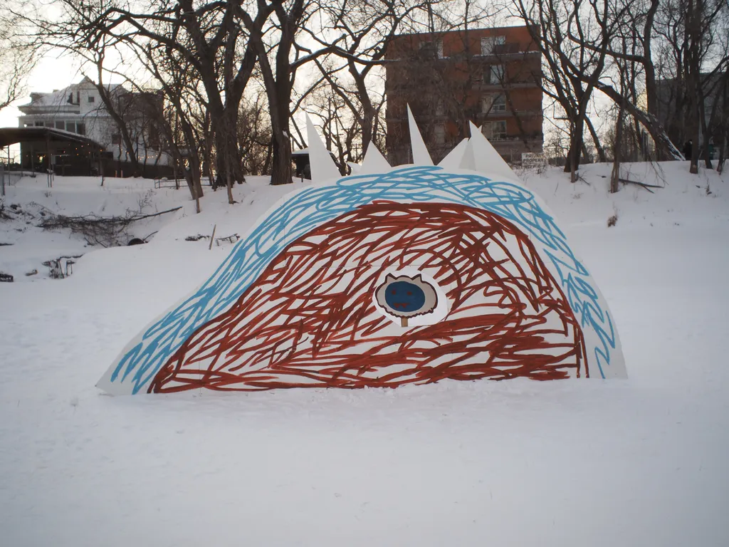 a warming hut built to resemble a child's depiction of a yeti in a cave