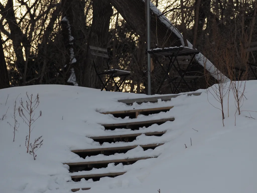 snowy stairs up to a patio set