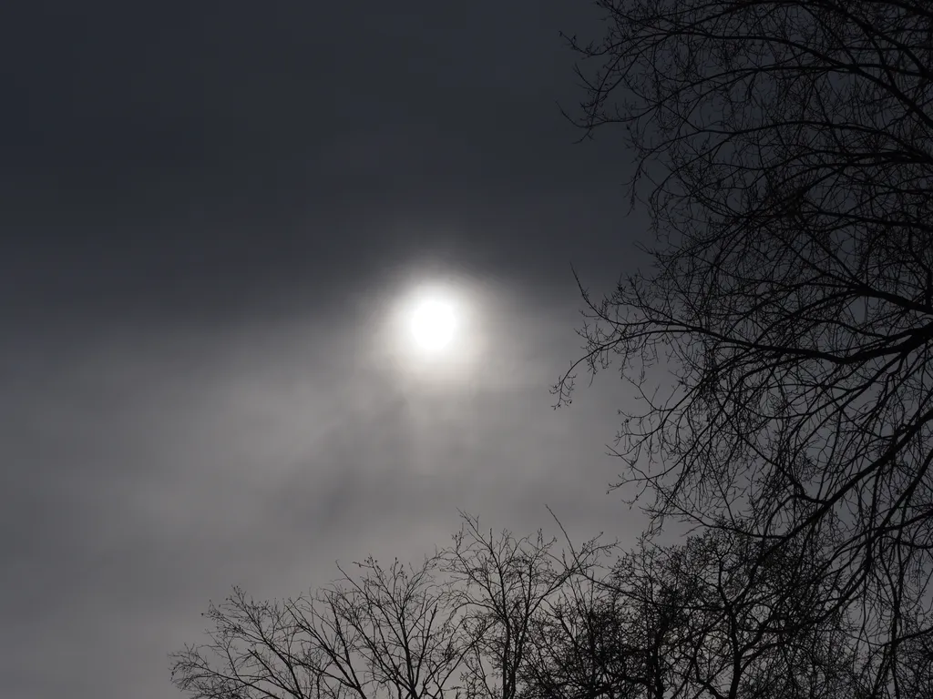 the sun behind clouds