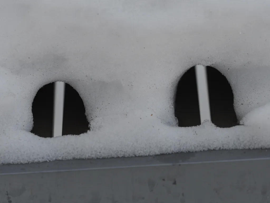 holes in the snow on a patio table