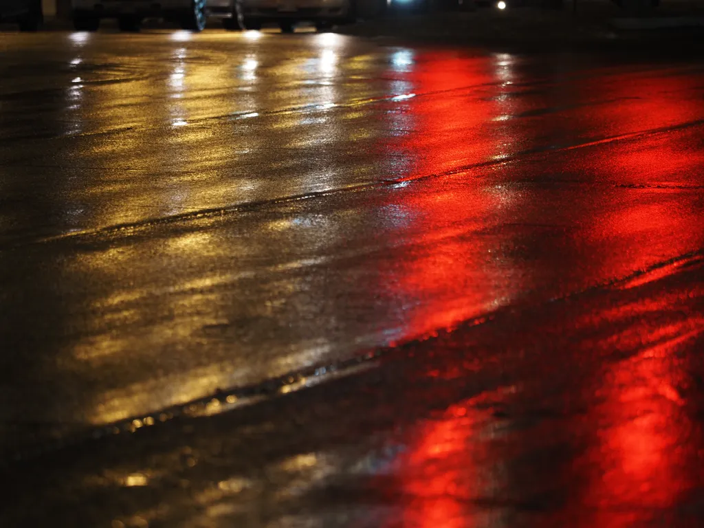 lights reflecting on a wet street at night