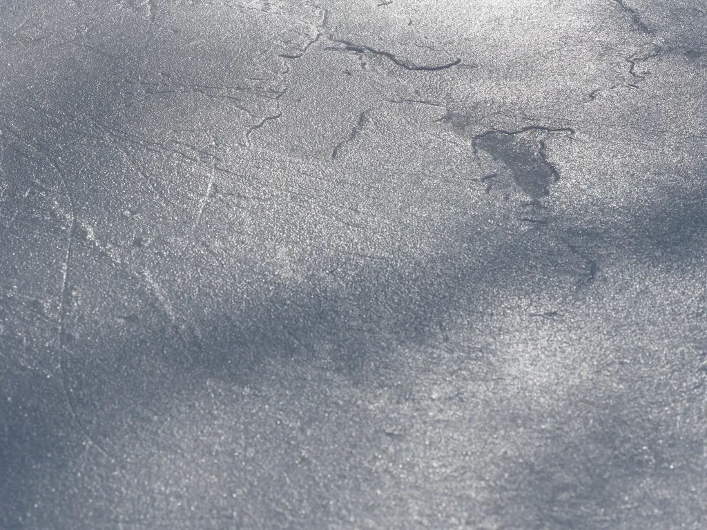 the uneven surface of a rink on a warm day