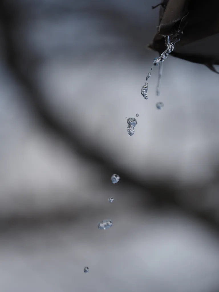 water streaming from a broken gutter