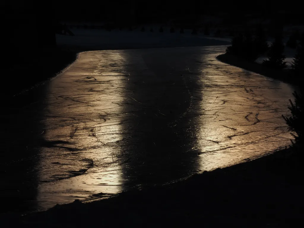 the setting sun reflecting on a frozen river