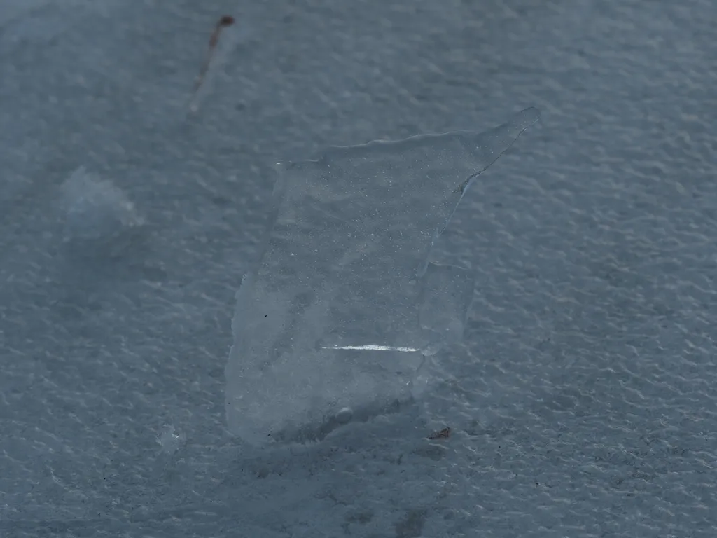 a chunk of ice sticking out of a hole