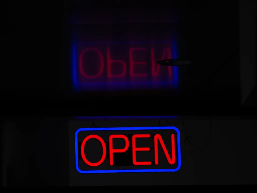 an open sign reflected in a ceiling