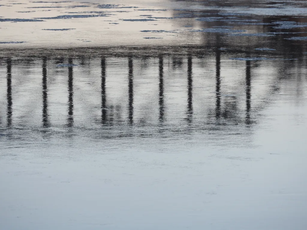 a bridge reflected in a river