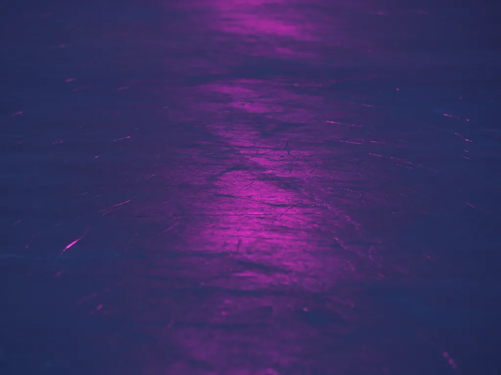 a pink spotlight reflecting on ice