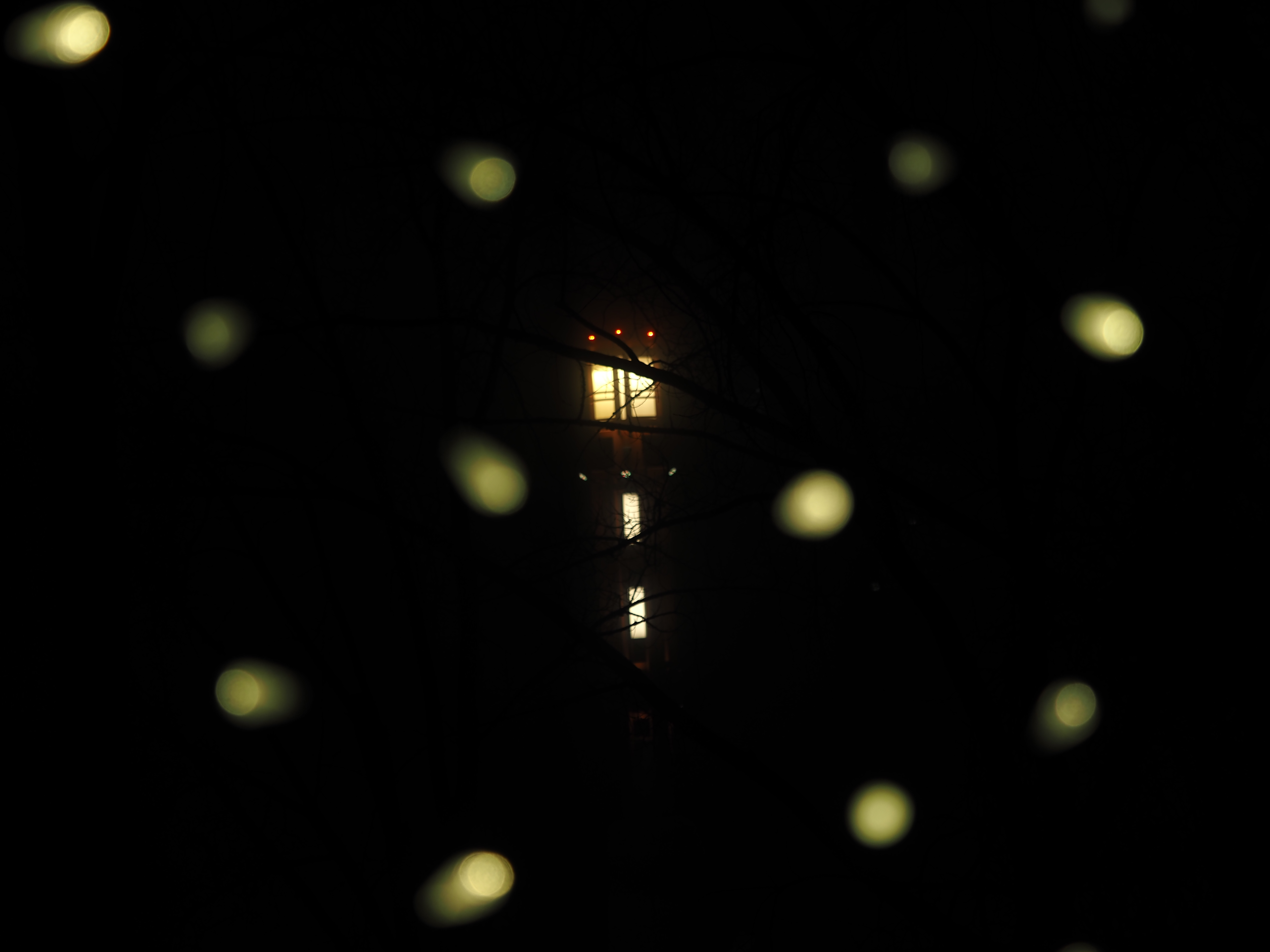 a light viewed through an archway of lights