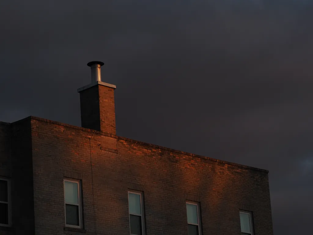 a brick building lit up by the setting sun