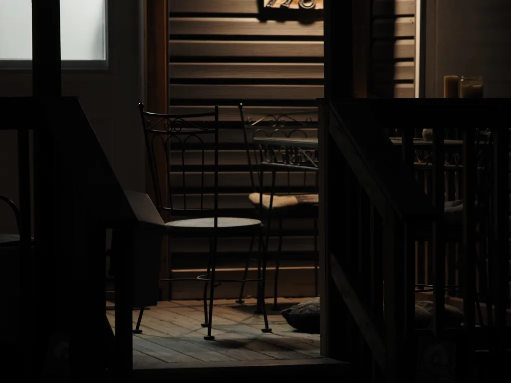 an empty patio furniture set at night