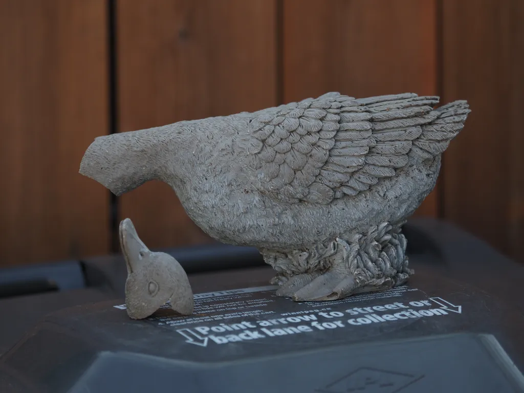 a broken duck statue