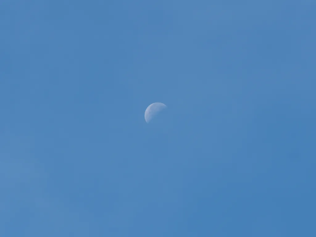 the moon in a blue sky