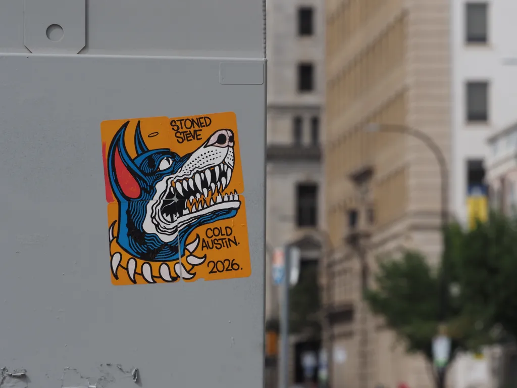 a drawing of a dog on a utility box with the text 