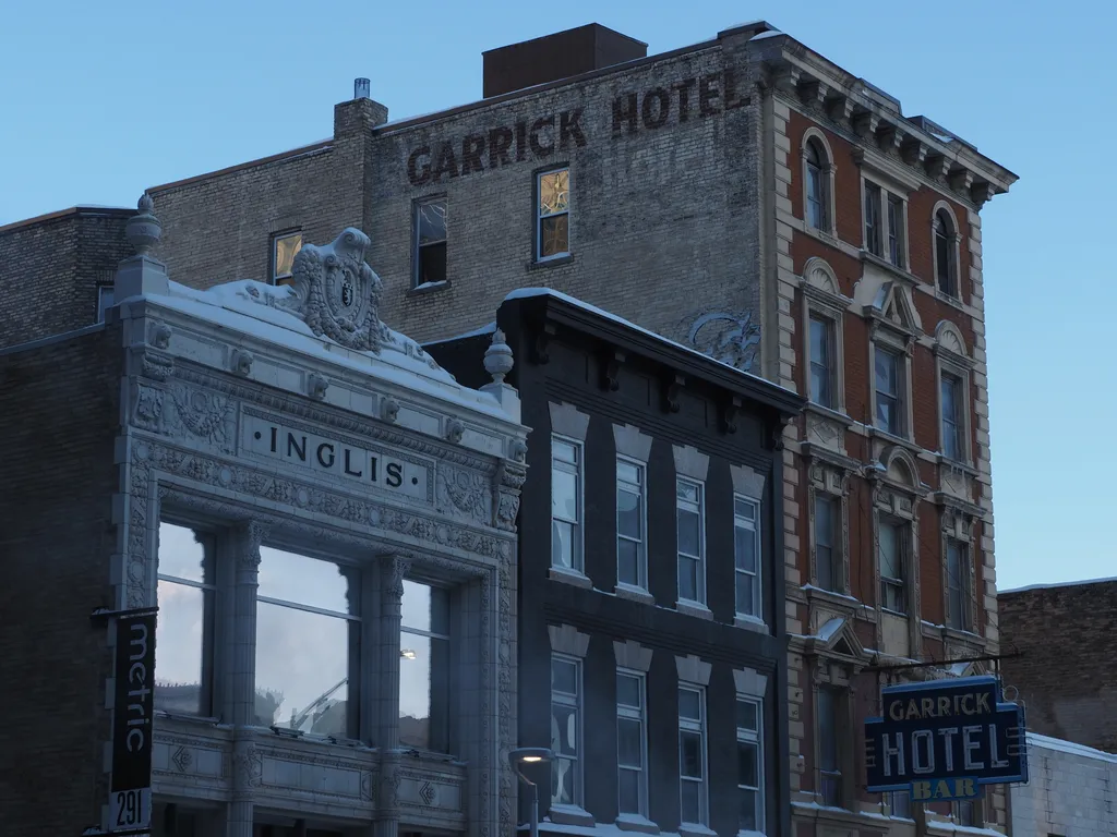 three old brick buildings (each slightly taller than the last). The final building has 