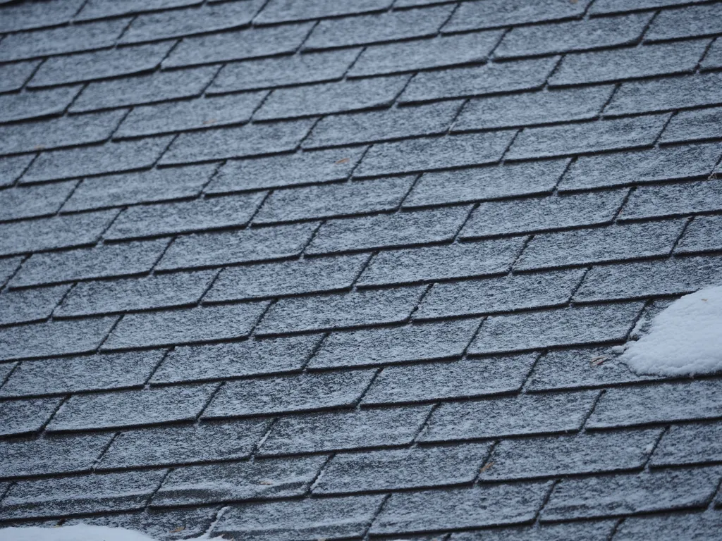 snow-covered shingles of a roof