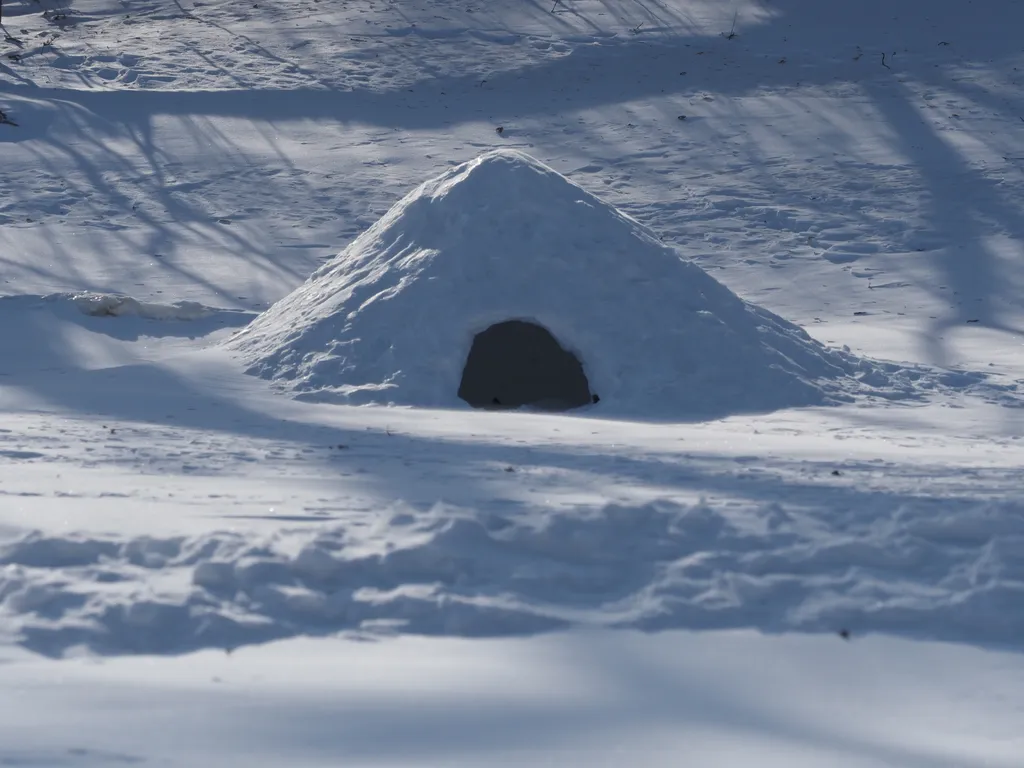 a snow hut on a frozen river