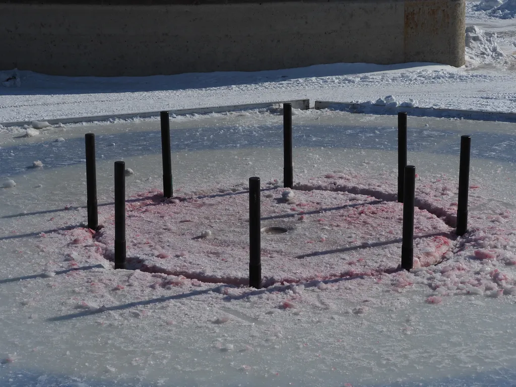 a giant (curling-sized) crokinole board built on the ice