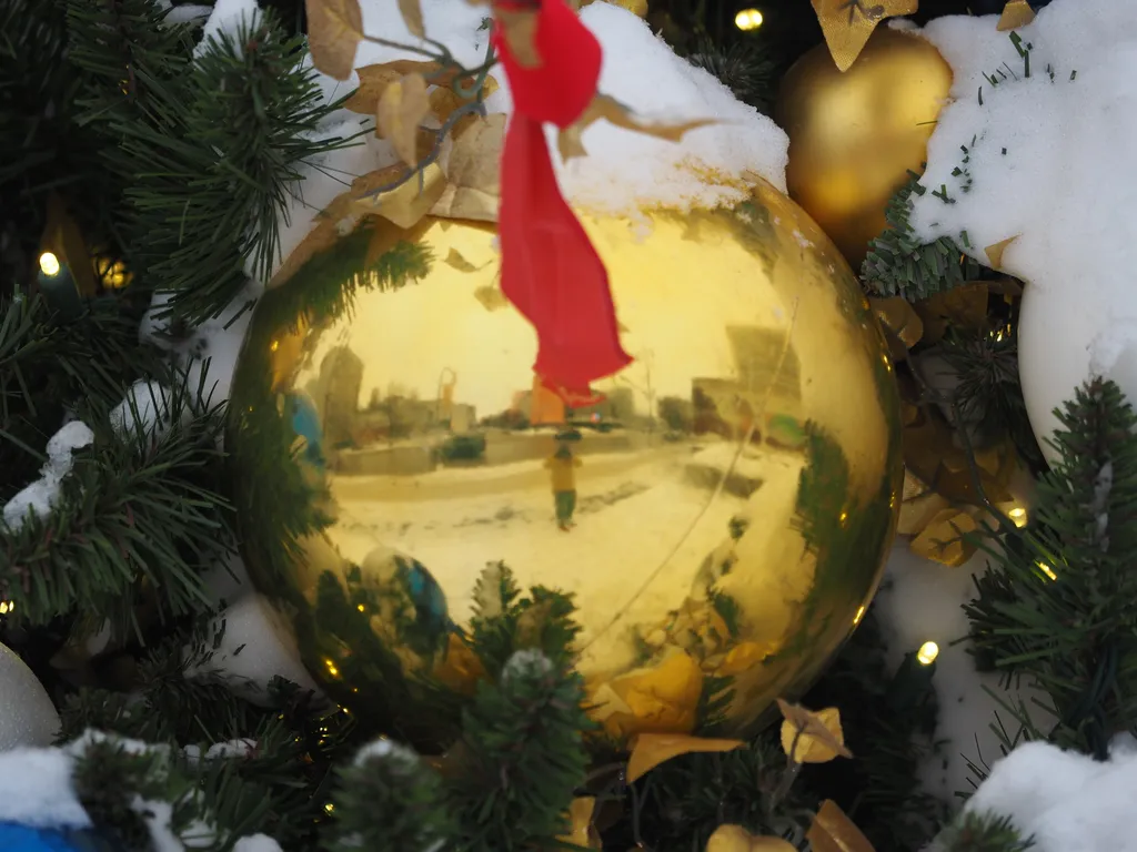 a selfie taken in a large yellow bauble on an artificial tree