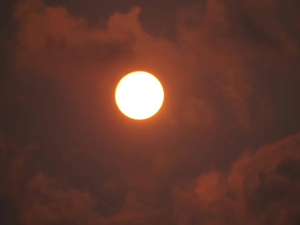 a red sun in a pink-red sky