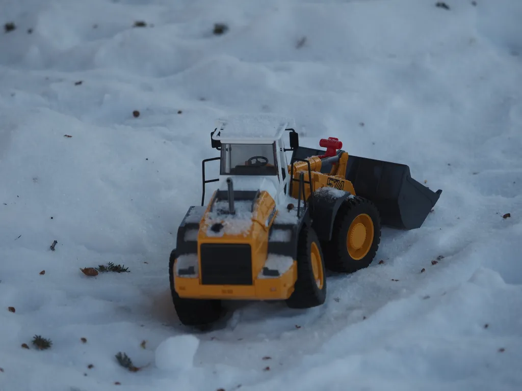 a toy front-end-loader in the snow