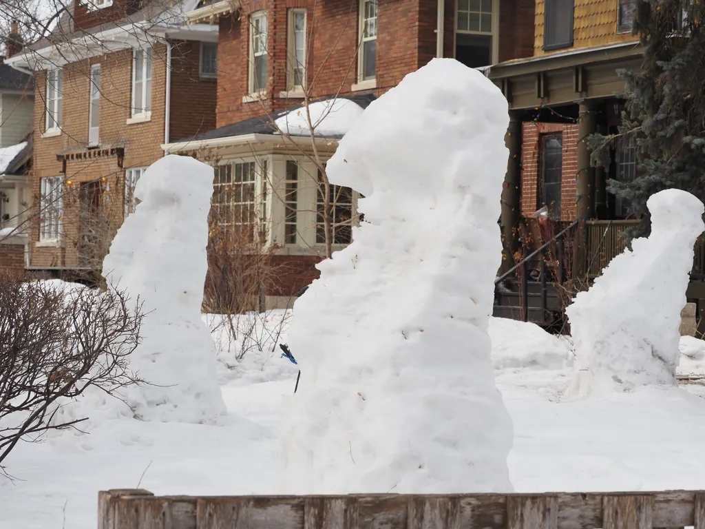 large snowmen built to resemble moai